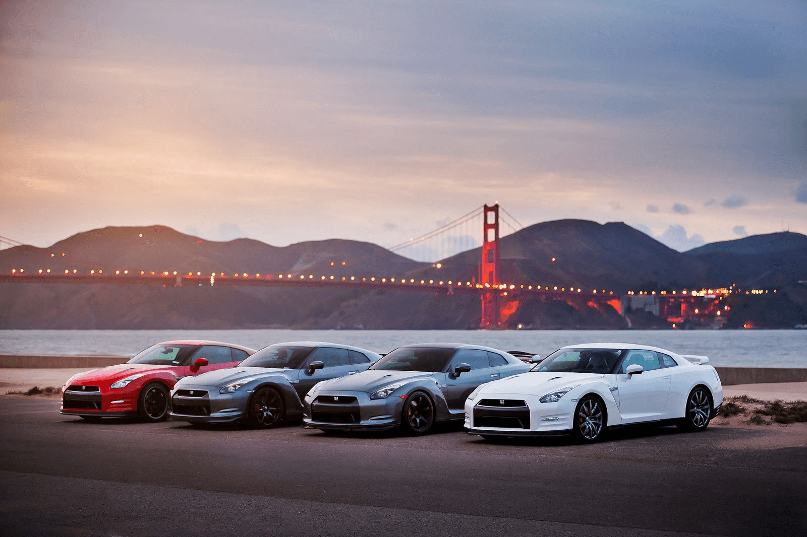 Collection of luxury cars with Golden Gate Bridge in background
